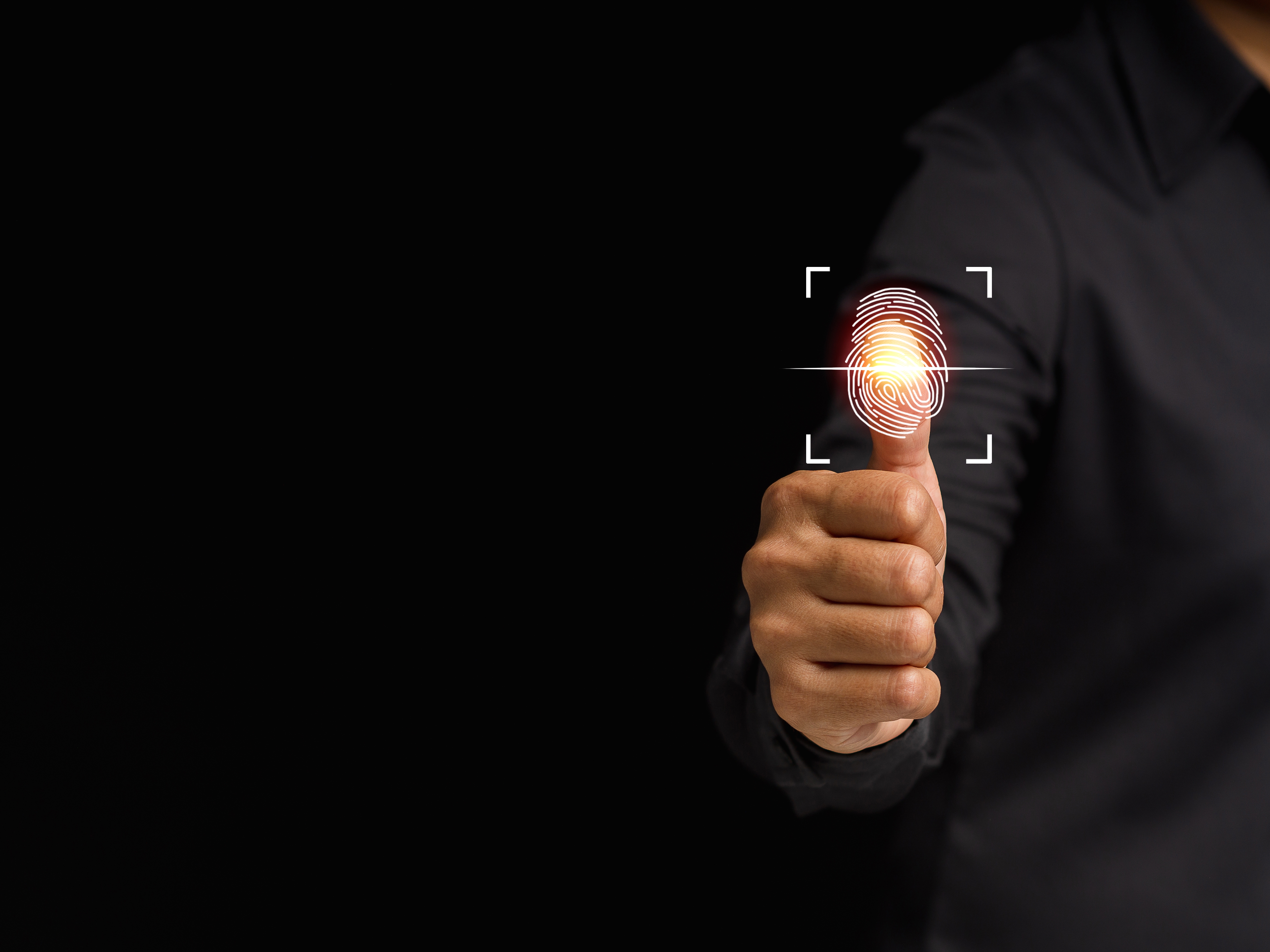 A person's thumb being scanned for biometric identification, with a digital overlay.