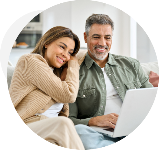 Happy couple looking at a laptop